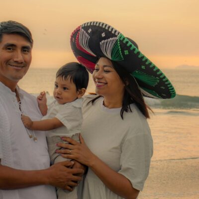 A joyful family moment captured on a beach at sunset, embodying love and happiness.
